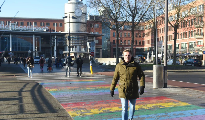 Foto van Eddie Altenburg lopend op het gekleurde zebrapad bij het station